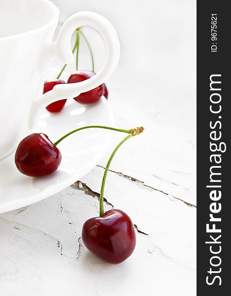 Some cherries in cup over grunge background