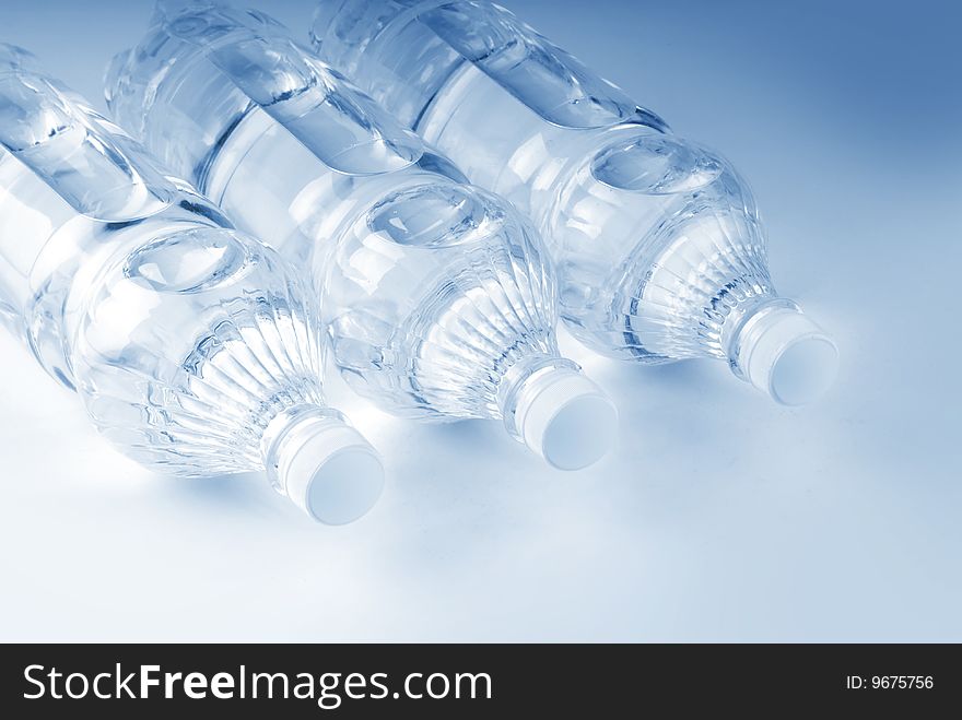 Bottled water over a white-blue background. Bottled water over a white-blue background