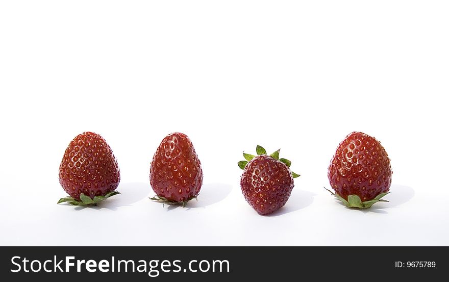 Four fresh strawberries on a white background. Four fresh strawberries on a white background