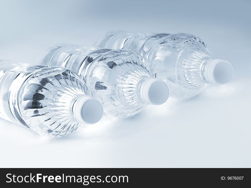 Bottled water over a white-blue background. Bottled water over a white-blue background