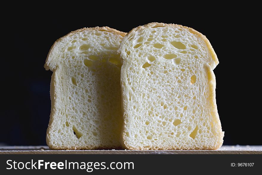 Close up of two bread slices on a black background