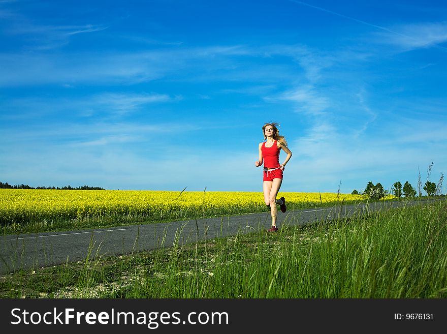 An image of a young girl running on the road. An image of a young girl running on the road