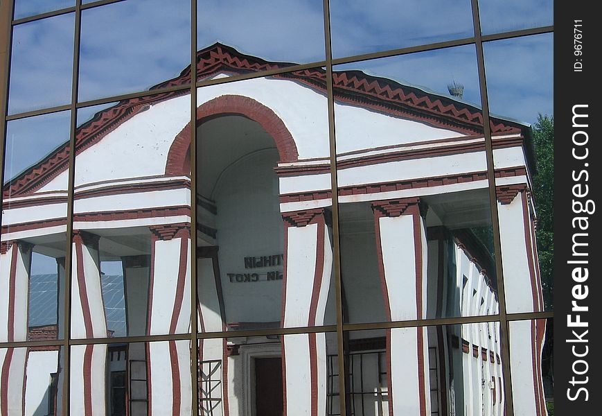 Reflection of white house at the glass window in Moscow. Reflection of white house at the glass window in Moscow