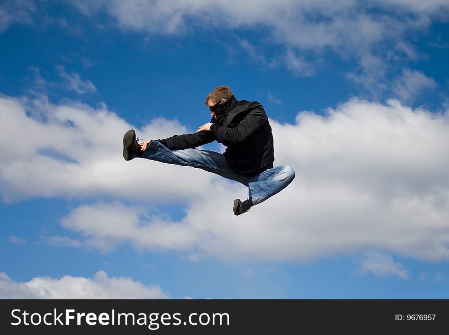 Man jumps on a background of the blue sky. Man jumps on a background of the blue sky