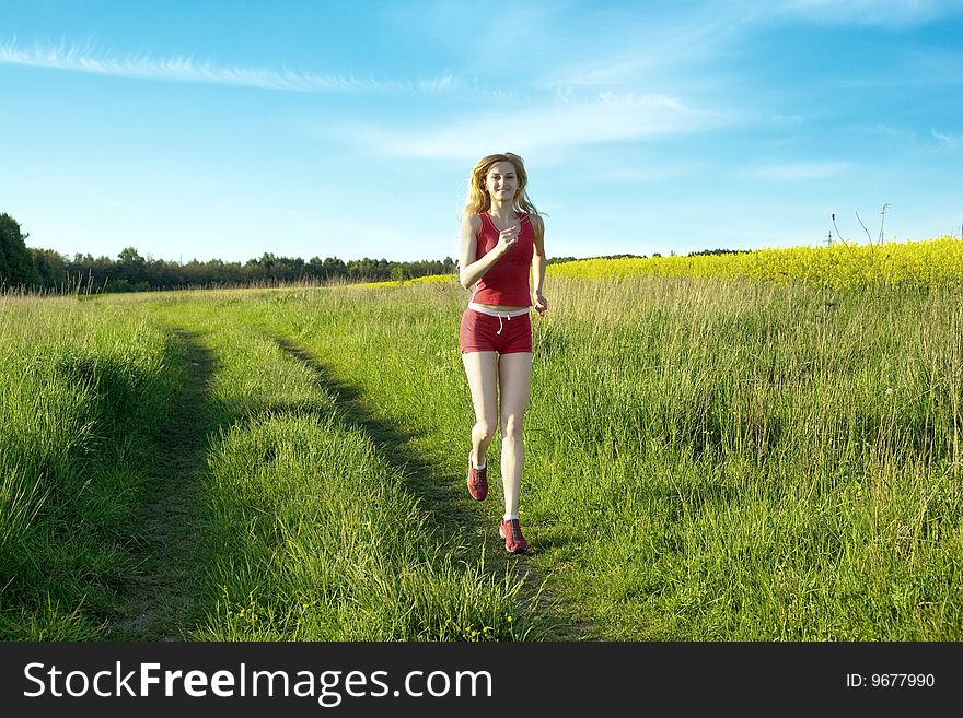 An image of a nice girl running in the field. An image of a nice girl running in the field