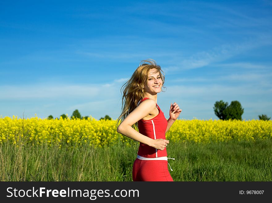 An image of a beautiful girl running in the field. An image of a beautiful girl running in the field