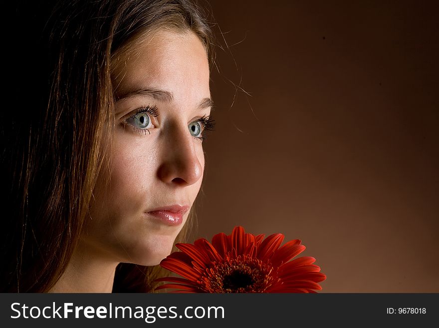 Young Woman With A Red Flower