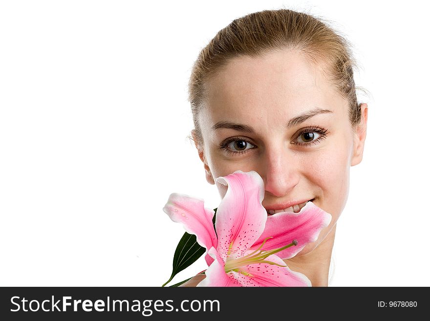 A portrait of a nice blond girl with a pink lily near her ace on a white background. A portrait of a nice blond girl with a pink lily near her ace on a white background