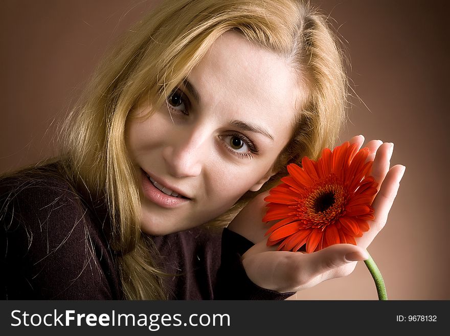 Blonde  posing with a red flower