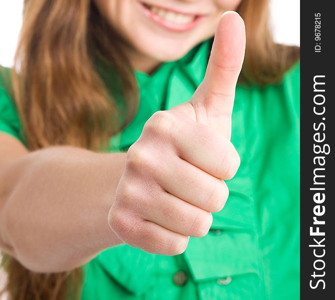 A cheerful young woman giving the thumb-up sign. A cheerful young woman giving the thumb-up sign