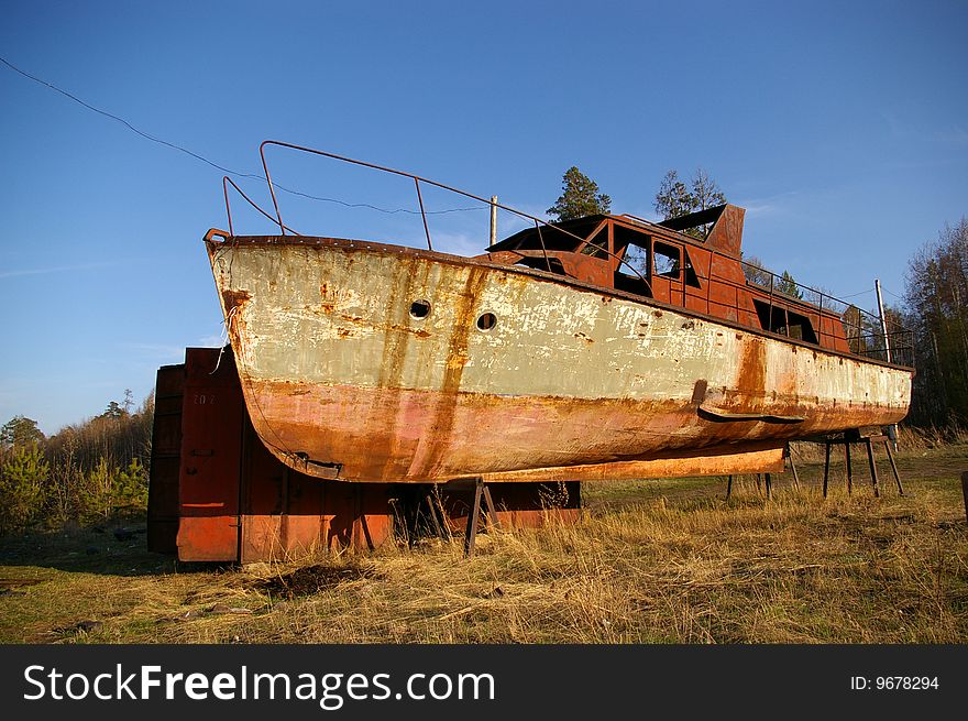 An old broken rusty boat. An old broken rusty boat