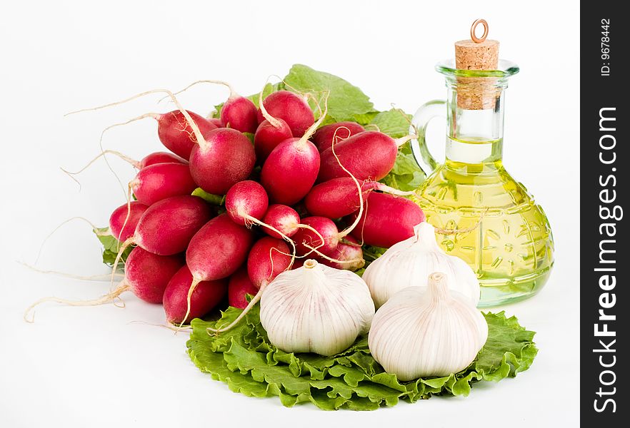 Green vegetables and a bottle of olive oil on the white background. Green vegetables and a bottle of olive oil on the white background