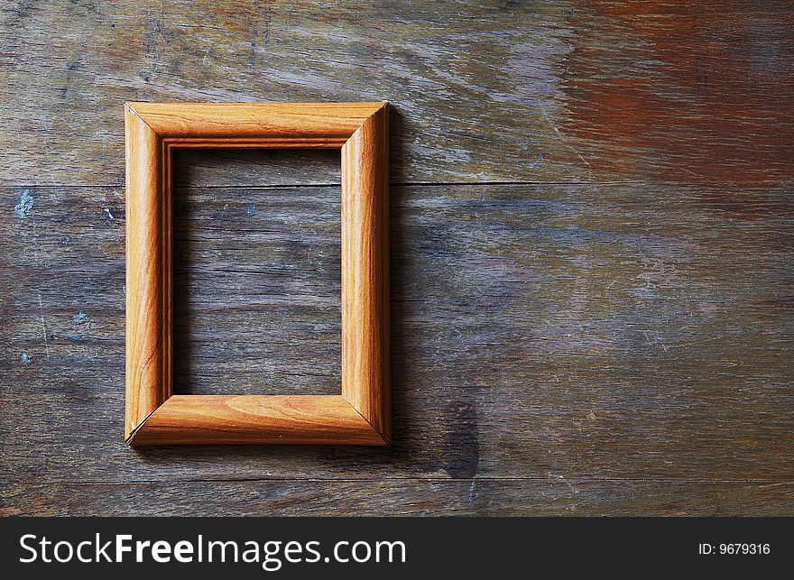 Empty frame on wooden background