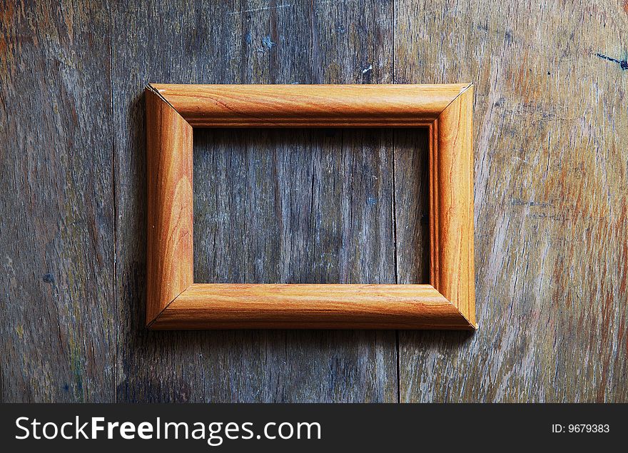 Empty frame on wooden background