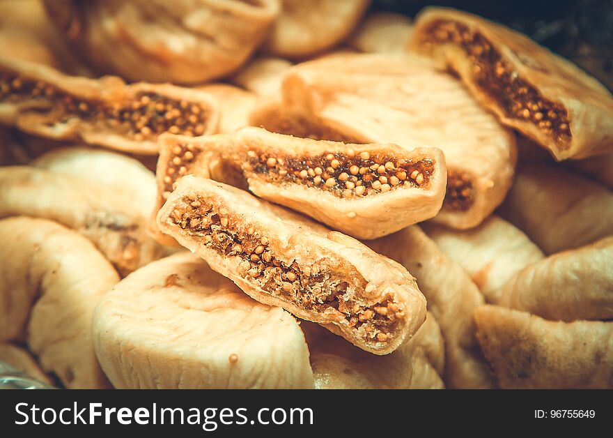 Dried fruits background, dried figs close-up, selective focus, toned picture. Dried fruits background, dried figs close-up, selective focus, toned picture