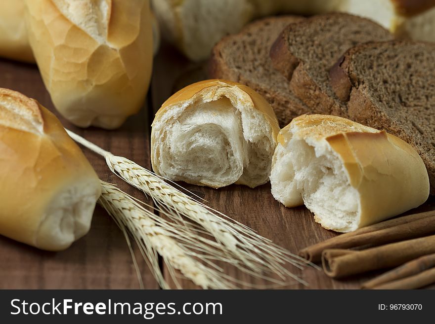 Sliced Bread Beside Wheat on Table