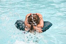 Girl In A Pool Being Splashed Royalty Free Stock Image