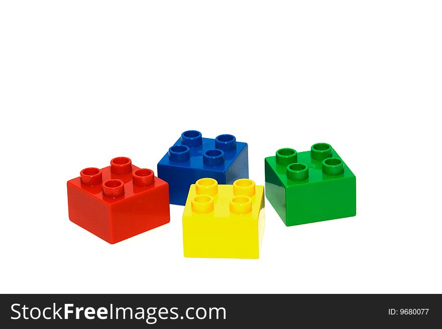 A collection of brightly coloured building bricks isolated on a white background. A collection of brightly coloured building bricks isolated on a white background