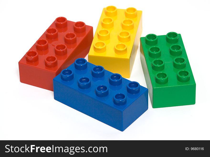 A collection of brightly coloured building bricks isolated on a white background. A collection of brightly coloured building bricks isolated on a white background