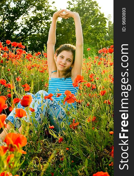 Portrait teen girl with poppy on nature