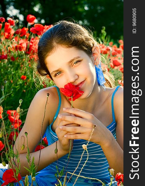 Portrait teen girl with poppy on nature