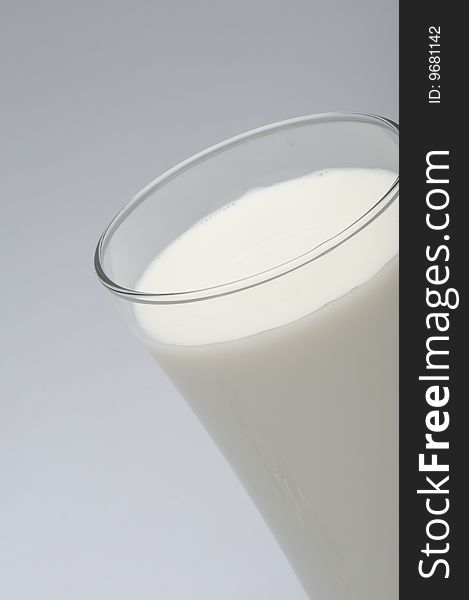 Glass Of Milk On Gray Background