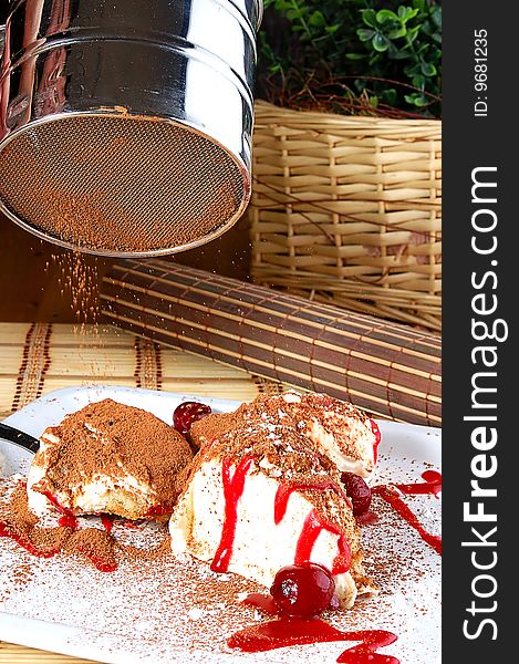 The Ice-cream strewed cocoa on a white dish with a cherry