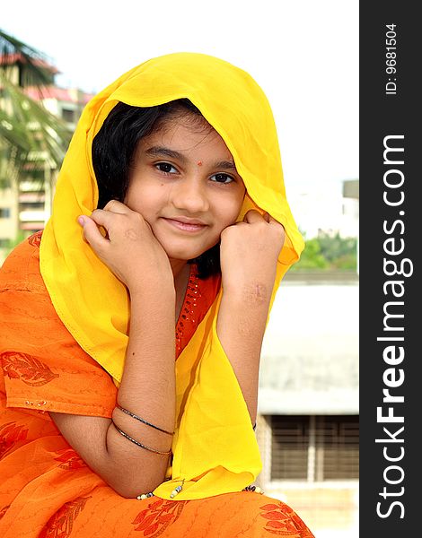 A beautiful Indian girl happily smiling in a soft and nice mood. A beautiful Indian girl happily smiling in a soft and nice mood.