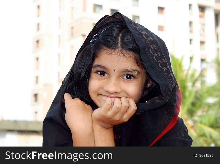 A traditional Indian girl giggling in an extremely happy mood. A traditional Indian girl giggling in an extremely happy mood.