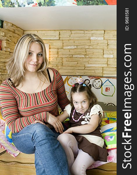 Girl Sitting With Mother