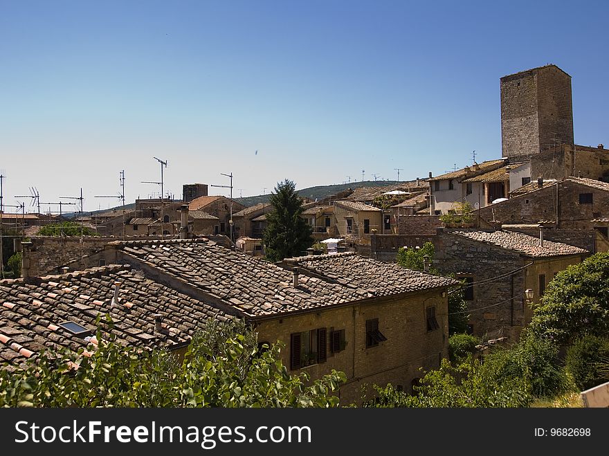 View over rooftops and Tuscan landscape in San Gimignano, Tuscany,Italy. View over rooftops and Tuscan landscape in San Gimignano, Tuscany,Italy