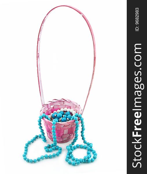 Colored Pearl Beads in Pink Wicker Basket Isolated