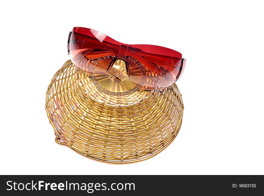 Sunglasses on inverted basket isolated on white background.