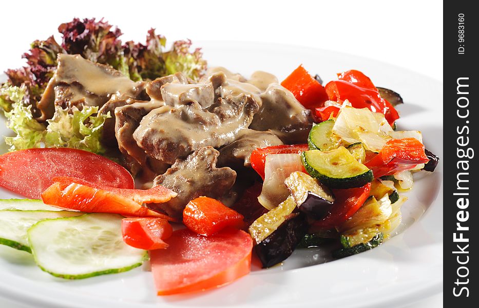 Stewed Beef with Vegetables and Fresh Vegetable on Plate. Stewed Beef with Vegetables and Fresh Vegetable on Plate