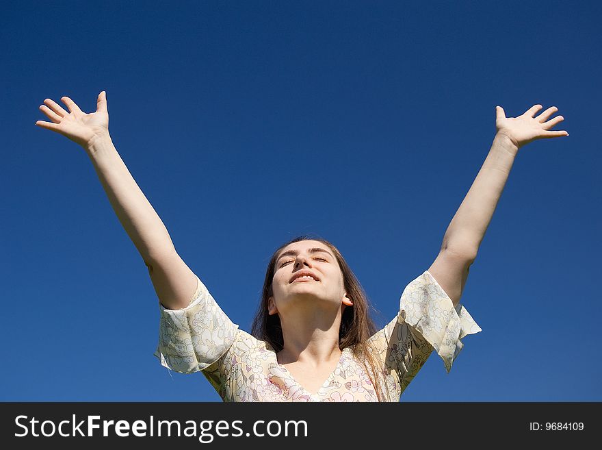 Woman is reaching to blue sky. Woman is reaching to blue sky
