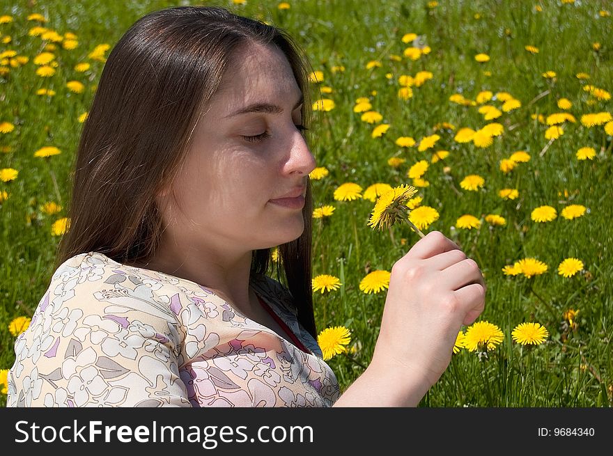 Young woman on colour meadow with dandelion. Young woman on colour meadow with dandelion