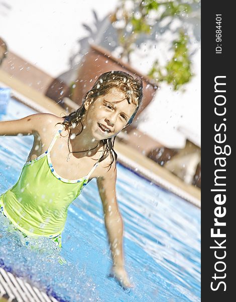 Portrait of little white girl having fun  in swimming pool. Portrait of little white girl having fun  in swimming pool