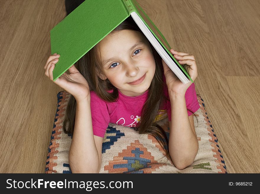 A young girl playing with a book. A young girl playing with a book