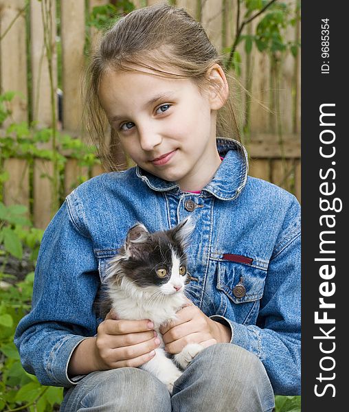 Teenage girl carrying a kitten. Teenage girl carrying a kitten