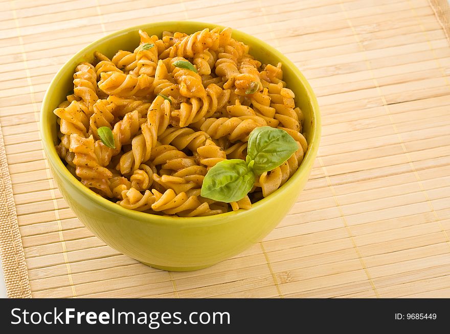Fresh pasta with tomato sauce and basil.