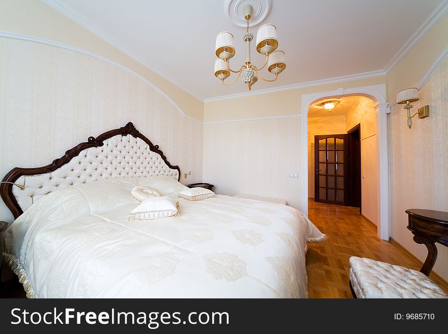 Beautiful bedroom with a wide bed in modern flat