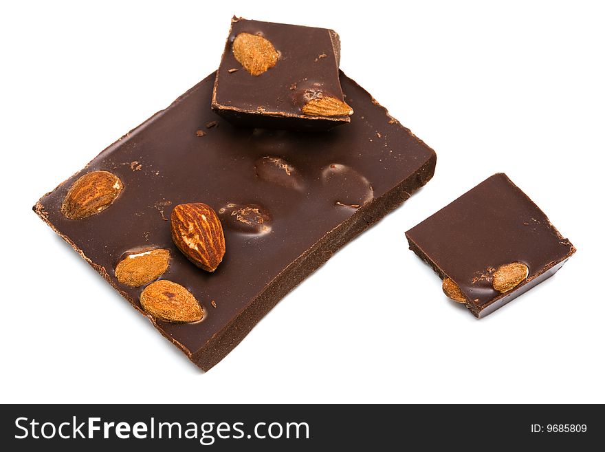 Dark chocolate with nuts on white background