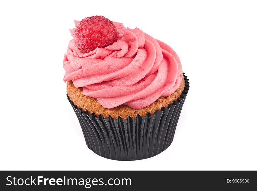 A lovely looking cupcake, with a raspberry on top, isolated on a white background. A lovely looking cupcake, with a raspberry on top, isolated on a white background