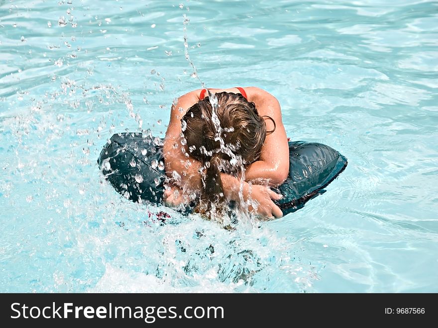 Girl in a Pool Being Splashed