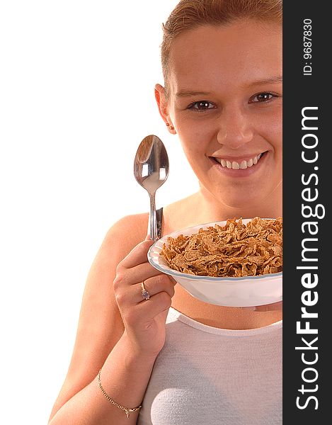 An lovely young woman holding a bowl of cereal and the spoon is ready to have her healthy breakfast. An lovely young woman holding a bowl of cereal and the spoon is ready to have her healthy breakfast.