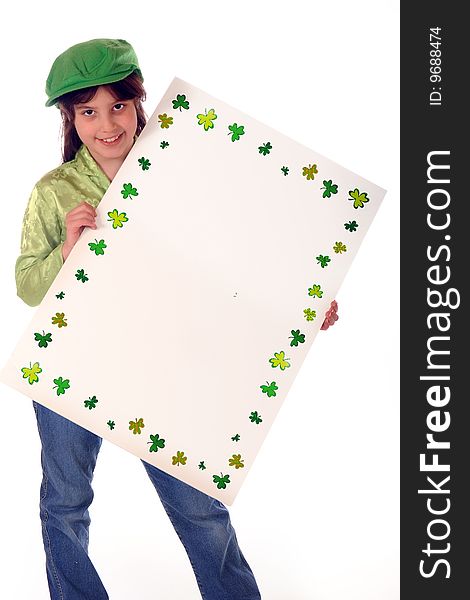 A shamrock-bordered sign left blank for your message. Sign is being held by a happy elementary girl dressed in green. Isolated on white. A shamrock-bordered sign left blank for your message. Sign is being held by a happy elementary girl dressed in green. Isolated on white.