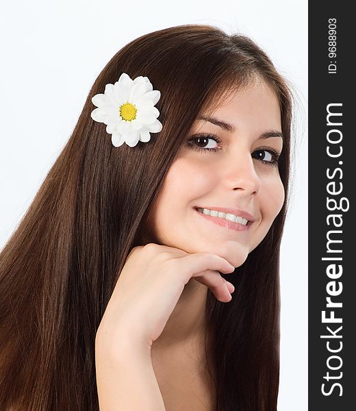 Portrait of a pretty young  girl with a flower in her hair. Portrait of a pretty young  girl with a flower in her hair