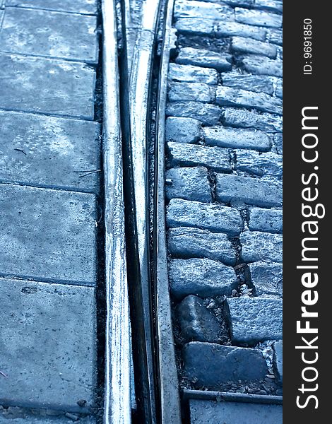 A closeup of a tram rail switch with city pavement. A closeup of a tram rail switch with city pavement