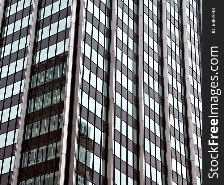 Reflections of other building in a building with wall of windows. Reflections of other building in a building with wall of windows.