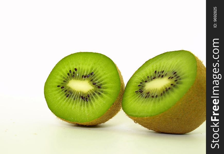 Two sliced kiwis against a white background.